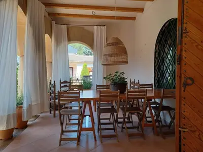 a dining room with a wooden table and chairs at Can Puig Barata, Aiguafreda in Aiguafreda