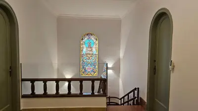 a staircase with a stained glass window in a church at Can Puig Barata, Aiguafreda in Aiguafreda