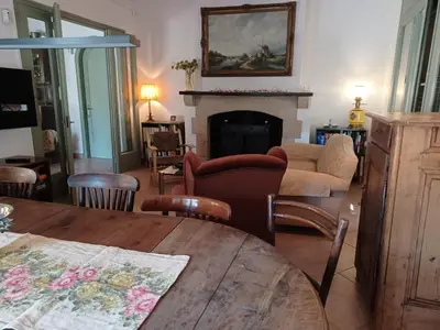a living room with a table and a fireplace at Can Puig Barata, Aiguafreda in Aiguafreda