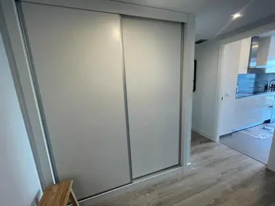 a sliding glass door in a room with a kitchen at Piso luminoso en Hospitalet de Llobregat in Barcelona