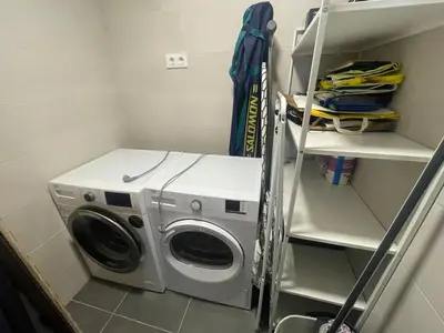 a washer and dryer in a laundry room at Piso luminoso en Hospitalet de Llobregat in Barcelona