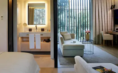a hotel room with a bed and a bathroom at ABaC H&R Barcelona Monument in Barcelona