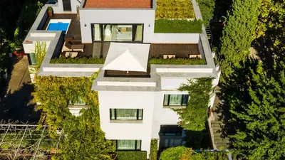 an aerial view of a white building with plants at ABaC H&R Barcelona Monument in Barcelona