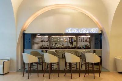 a bar with stools in front of aega lounge at ABaC H&R Barcelona Monument in Barcelona