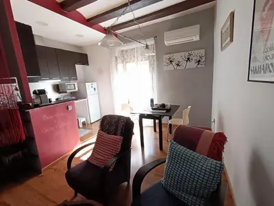 a kitchen and a living room with a table and chairs at Ca la Fiona in Monistrol