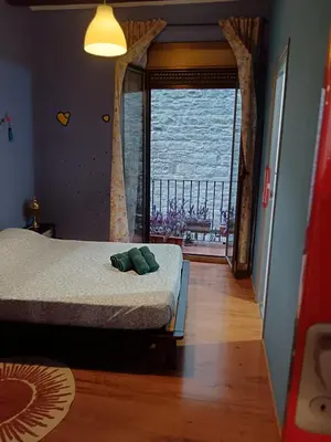 a bedroom with a bed and a large window at Ca la Fiona in Monistrol