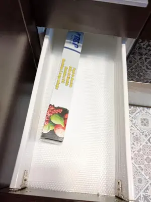an open drawer of a refrigerator with a magazine at Ca la Fiona in Monistrol