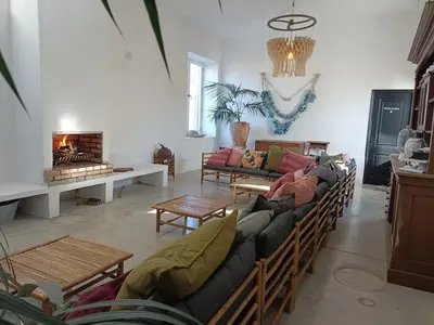 a living room with a couch and a fireplace at Soul Farm Mas els Igols in Torrellas de Foix