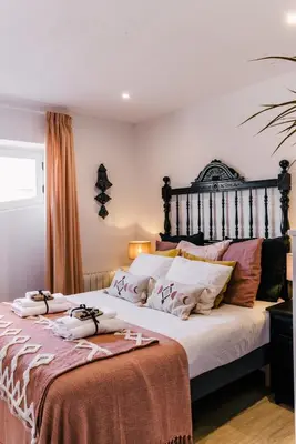 a bedroom with a large bed with towels on it at Soul Farm Mas els Igols in Torrellas de Foix