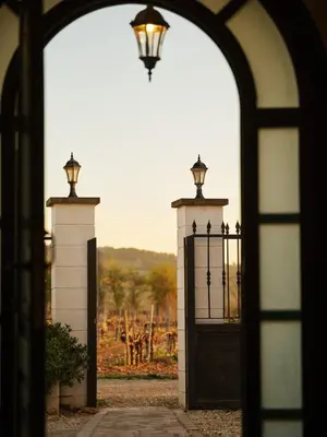 an archway with a gate with a light on top at Soul Farm Mas els Igols in Torrellas de Foix