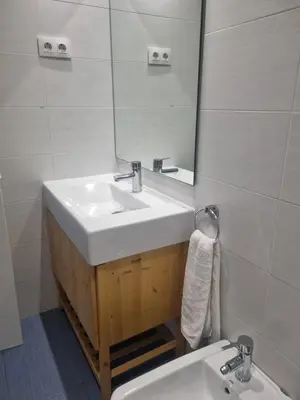 a white bathroom with a sink and a mirror at 1 Habitación Matrimonial Privada con baño incluido in Barcelona