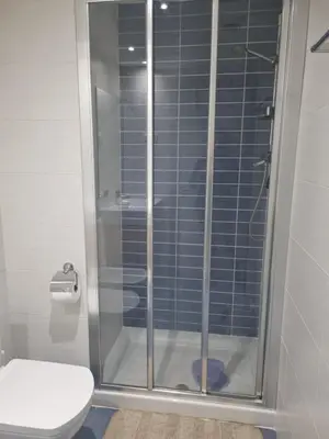 a shower stall in a bathroom with a toilet at 1 Habitación Matrimonial Privada con baño incluido in Barcelona