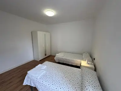 a small room with two beds and a door at Esglesia 2 in Arenys de Mar