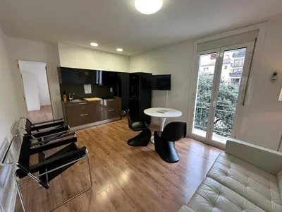 a living room with a white table and chairs at Esglesia 2 in Arenys de Mar