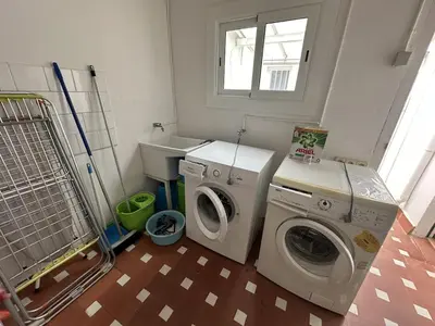 a laundry room with a washing machine and a washer at L'Esglesia 3 in Arenys de Mar