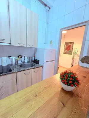 a kitchen with a table with a bowl of flowers on it at Amazing and stylish flat for 4 people with breakfast included 2 blocks away from Poblenou beach in Barcelona