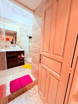 a bathroom with a door and a sink and a mirror at Amazing and stylish flat for 4 people with breakfast included 2 blocks away from Poblenou beach in Barcelona
