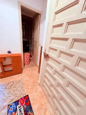 a wooden door in a room with a rug next to it at Amazing and stylish flat for 4 people with breakfast included 2 blocks away from Poblenou beach in Barcelona
