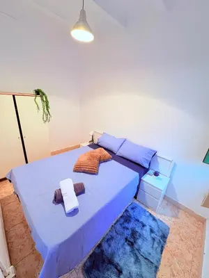 a bedroom with a blue bed with towels on it at Amazing and stylish flat for 4 people with breakfast included 2 blocks away from Poblenou beach in Barcelona