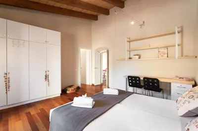 a bedroom with a large bed and white cabinets at Mas Vives, exclusiva masía del siglo XV in Cabrils
