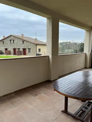 a balcony with a table and a view of a house at Can Sura in Campíns
