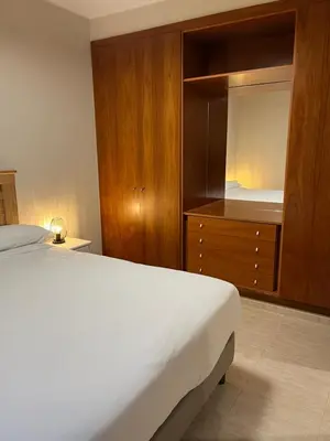 a bedroom with a bed and a dresser with a mirror at Can Sura in Campíns