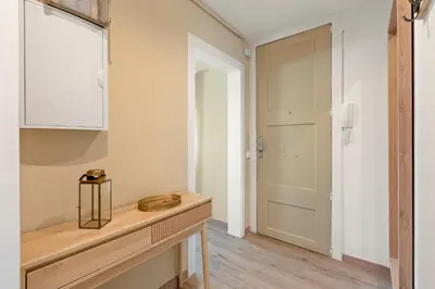 a room with a hallway with a door and a table at Flateli Pelayo H7 in Barcelona