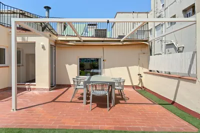 a patio with a table and chairs on a brick patio at Flateli Pelayo H7 in Barcelona