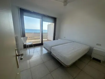 a bedroom with a bed and a view of the ocean at Can Xifre 1 in Arenys de Mar