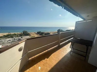a balcony with a bench and a view of the ocean at Can Xifre 1 in Arenys de Mar