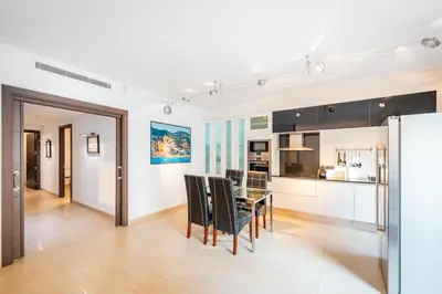 a kitchen and dining room with a table and chairs at InSitges Center in Sitges
