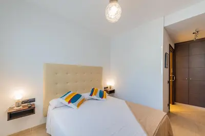 a bedroom with a large white bed with two pillows at InSitges Center in Sitges