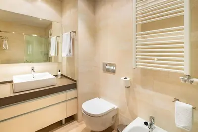 a bathroom with a white toilet and a sink at InSitges Center in Sitges