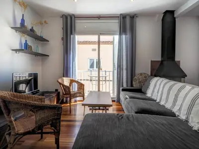 a living room with a couch and a table at Ollie Apartment by Hello Homes Sitges in Sitges