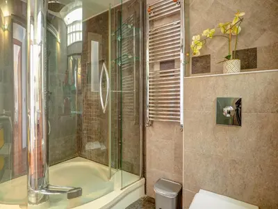 a bathroom with a shower with a glass door at Ollie Apartment by Hello Homes Sitges in Sitges