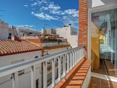 a balcony with a view of a city at Ollie Apartment by Hello Homes Sitges in Sitges
