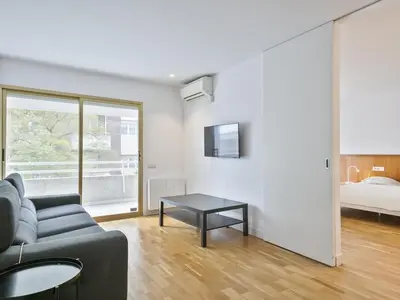 a living room with a couch and a table at Winahost Barcelona Pedralbes in Barcelona