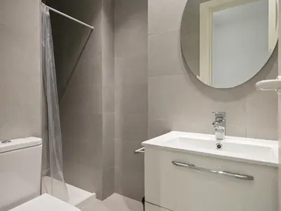 a bathroom with a toilet and a sink and a mirror at Winahost Barcelona Pedralbes in Barcelona
