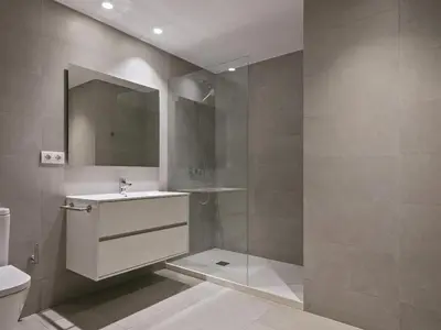 a bathroom with a sink and a shower with a mirror at Winahost Barcelona Pedralbes in Barcelona