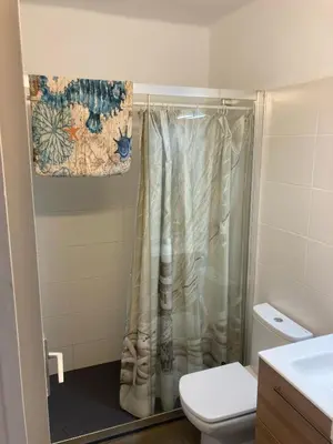 a bathroom with a shower with a toilet and a sink at Masnou nice view big apartment in Masnou