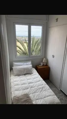 a bedroom with a white bed and a window at Masnou nice view big apartment in Masnou
