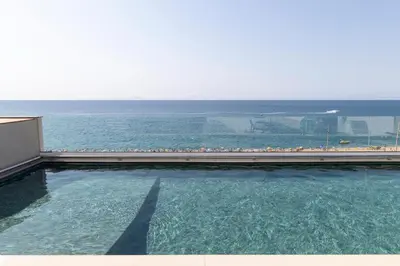 a swimming pool with a view of the ocean at Hotel Calella by Beatriz Hoteles in Calella