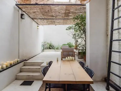 a dining room with a wooden table and chairs at Luxury 2 Story Apartment Near Passeig de Gracia in Barcelona