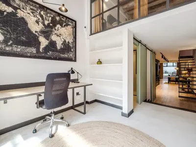 an office with a desk and a chair at Luxury 2 Story Apartment Near Passeig de Gracia in Barcelona