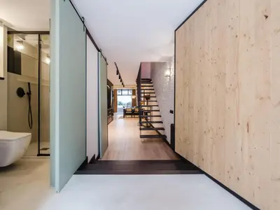 a hallway of a house with a staircase and a bathroom at Luxury 2 Story Apartment Near Passeig de Gracia in Barcelona