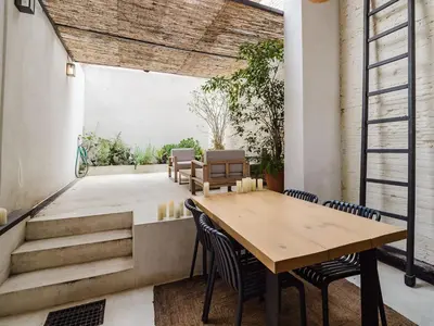 a dining room with a wooden table and chairs at Luxury 2 Story Apartment Near Passeig de Gracia in Barcelona