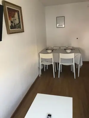 a dining room with a table and two chairs at Pis Sitges centre in Sitges