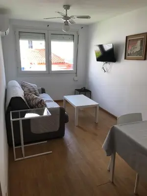 a living room with a couch and a table at Pis Sitges centre in Sitges