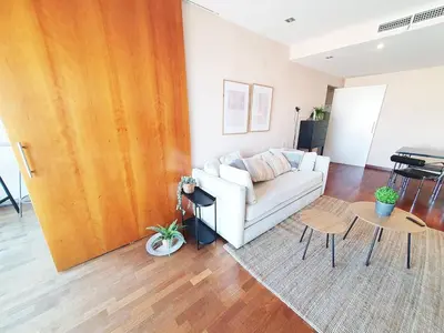 a living room with a white couch and a table at Modern apartment in Diagonal Mar in Barcelona