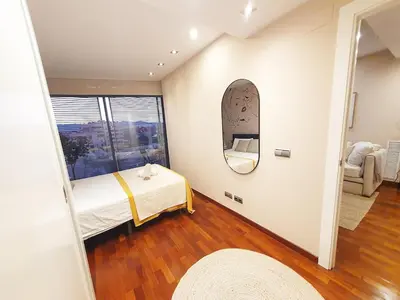 a bedroom with a bed and a large window at Modern apartment in Diagonal Mar in Barcelona